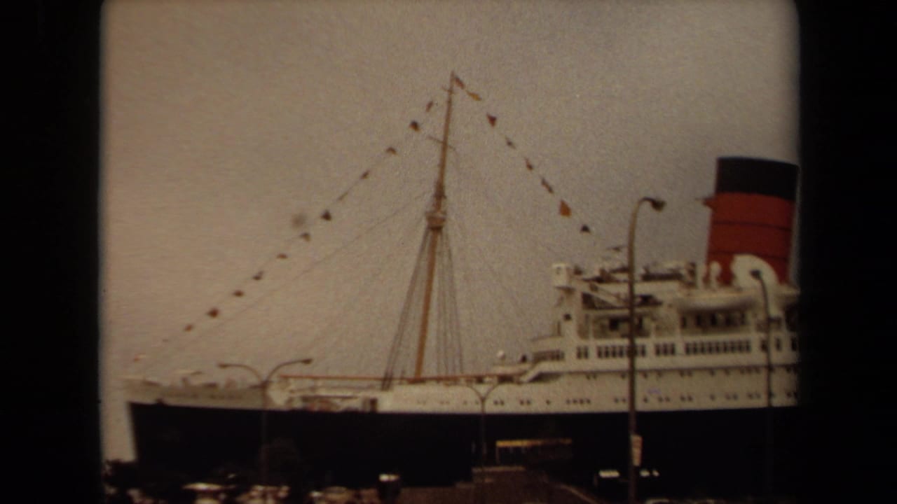 1971 Long Beach footage shows a large white passenger liner docked with mast bunting, a red-and-black funnel, and port lighting in view.