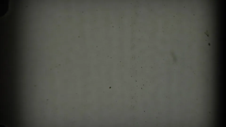 Underexposed or blank 8mm frame within the 1971 Long Beach reel, with visible dust and film gate marks.