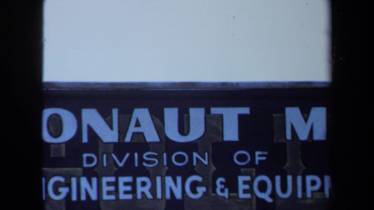 Close view of a blue industrial sign with cropped Argonaut Mine and engineering text.