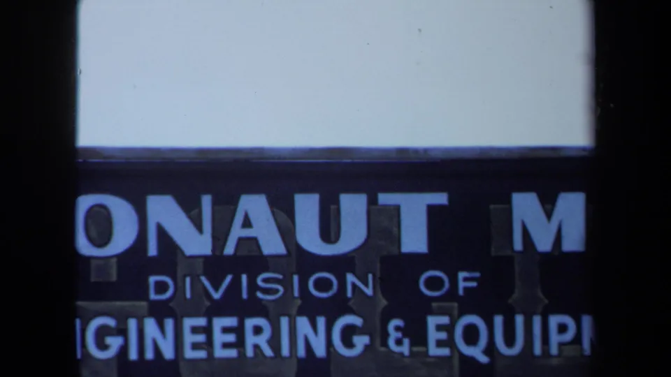 Close 1971 Maine frame of a blue Argonaut Mine sign with cropped words for division and engineering equipment.