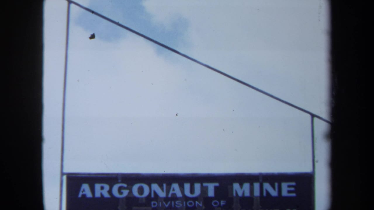 Closer view of the Argonaut Mine sign with sky and film-frame edge visible.