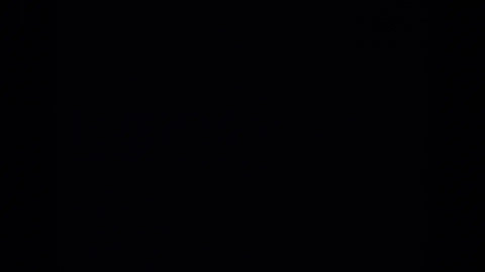 A mostly dark 8mm transition frame, with a sliver of the mine sign shot still visible at the edge.