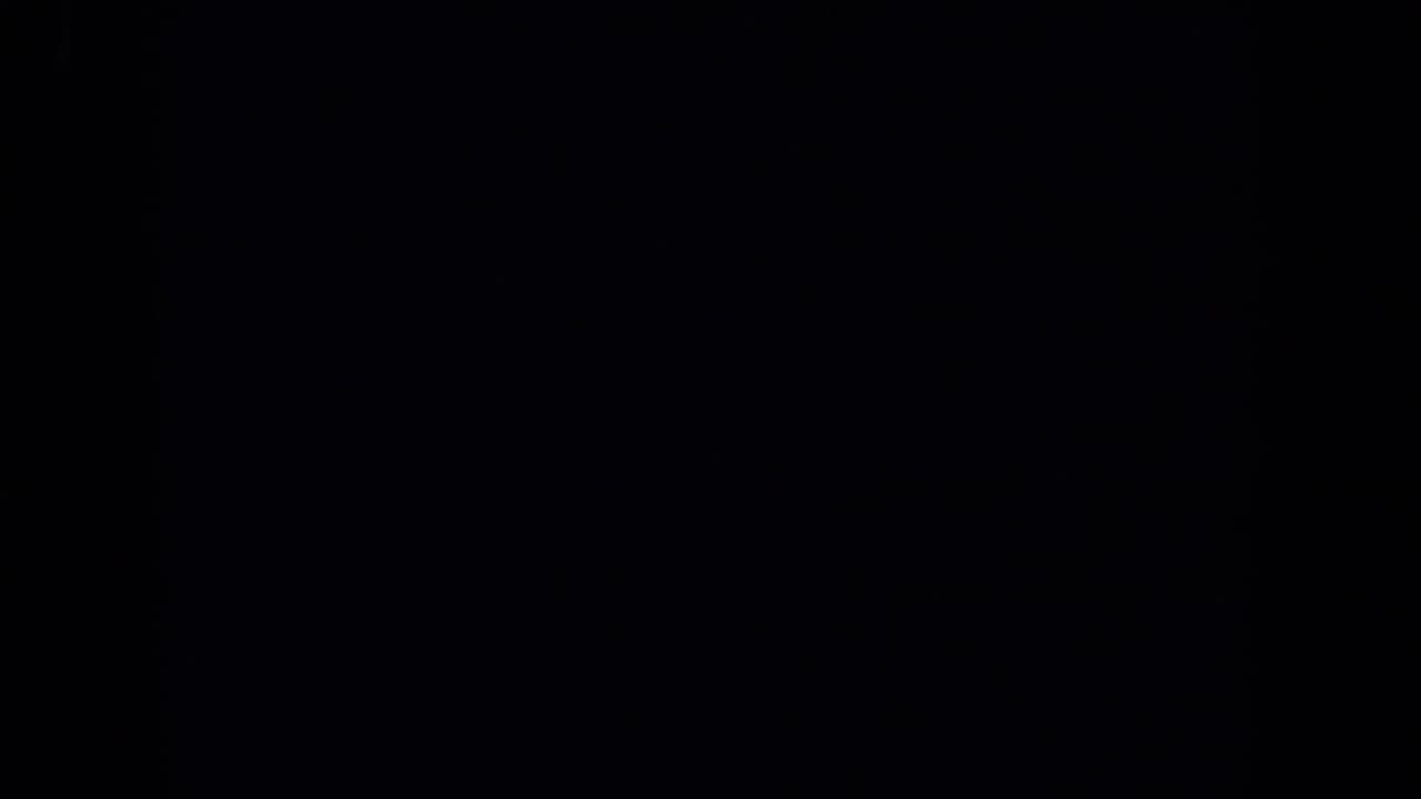 A mostly dark 1971 Maine 8mm frame, likely an underexposed or obscured moment before the waterside view becomes clear.