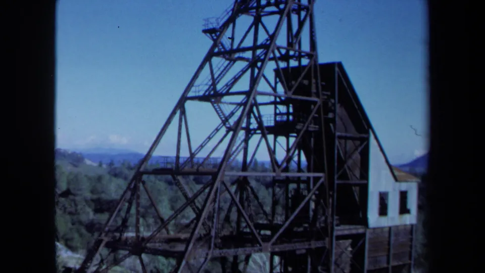 1971 Maine 8mm frame showing the derrick structure from midsection to base, including a small building.