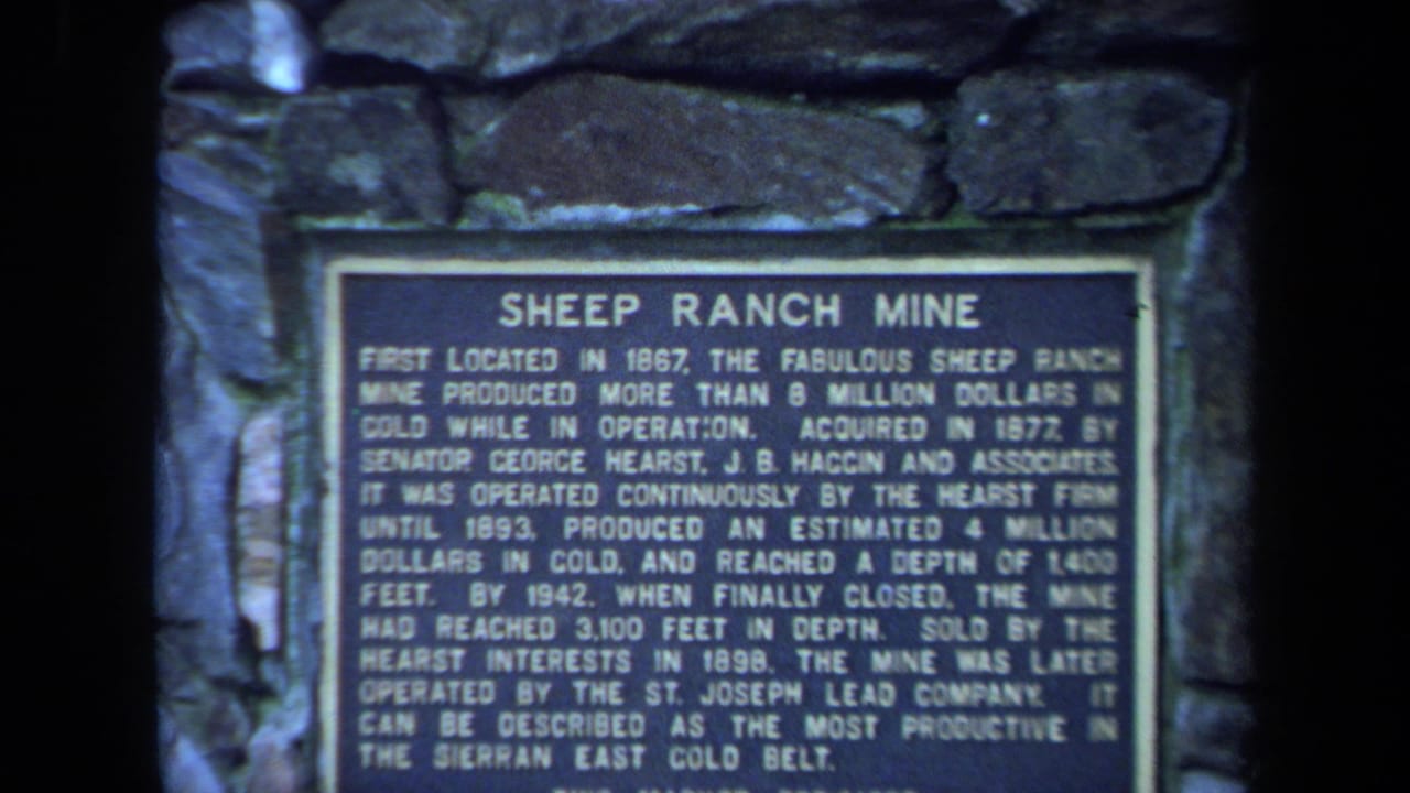 Close view of the Sheep Ranch Mine plaque with surrounding stonework.