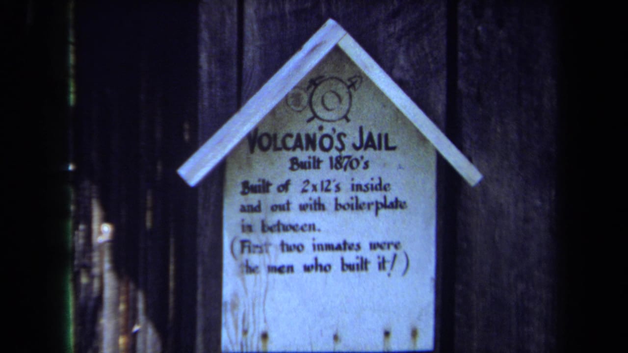 1971 Maine 8mm frame showing a close view of the Volcano's Jail sign mounted on a weathered wooden shack.
