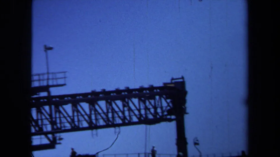The final frame shows a larger portion of the distant bridge truss and support in silhouette, consistent with 1971 Maine 8mm footage.