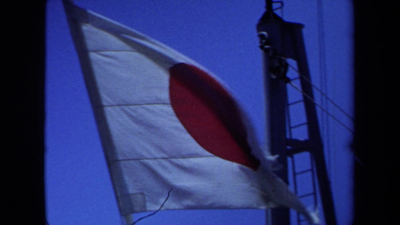 1971 Maine 8mm frame showing a Japanese flag fluttering near ship mast hardware against blue sky.