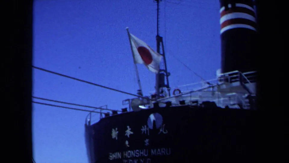 1971 Maine frame showing the Shin Honshu Maru name on the hull beneath a Japanese flag and ship rigging.