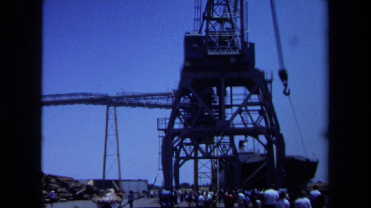 1971 Maine 8mm frame showing a massive industrial crane with a crowd gathered near its base.