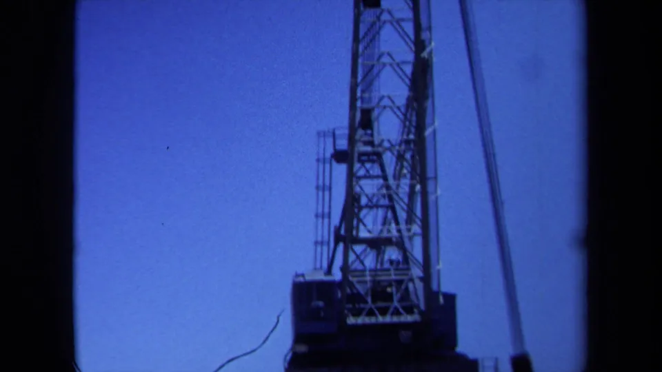 Final 1971 Maine frame looking high on the crane, with open sky and the hook line at right.