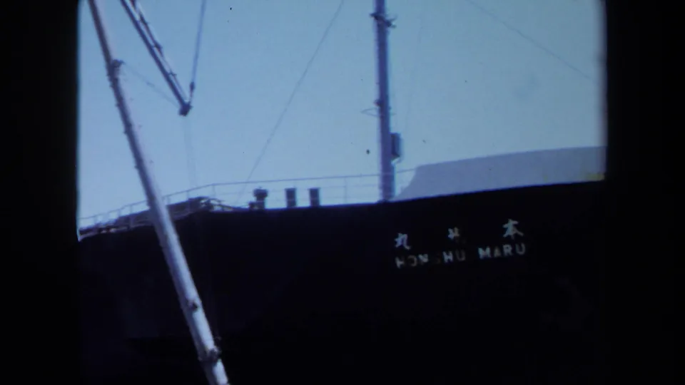 1971 Maine frame of the Honshu Maru hull name, ship rigging, mast details, and clear sky at a dock.