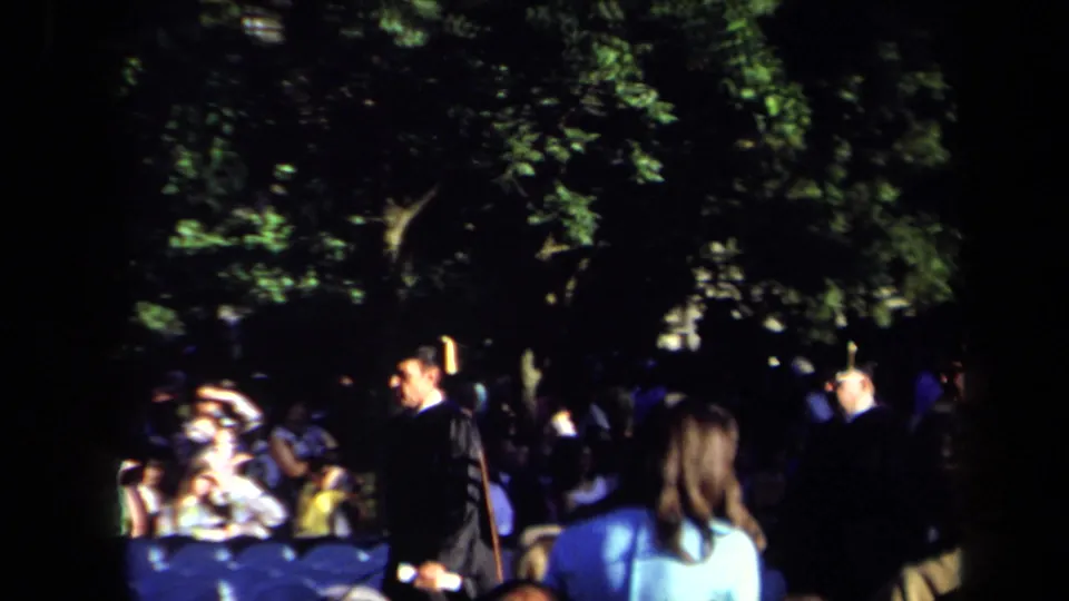 A Sacramento 1971 outdoor gathering appears under leafy trees, with several adults visible in shade near the end of the clip.
