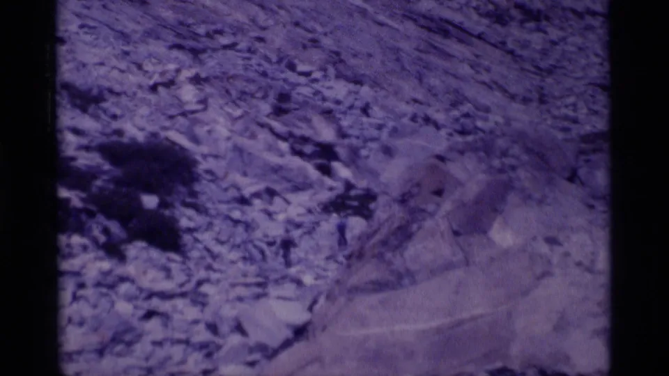 Close 8mm view of rough alpine ground in Minaret Wilderness, with visible grain and purple color shift.