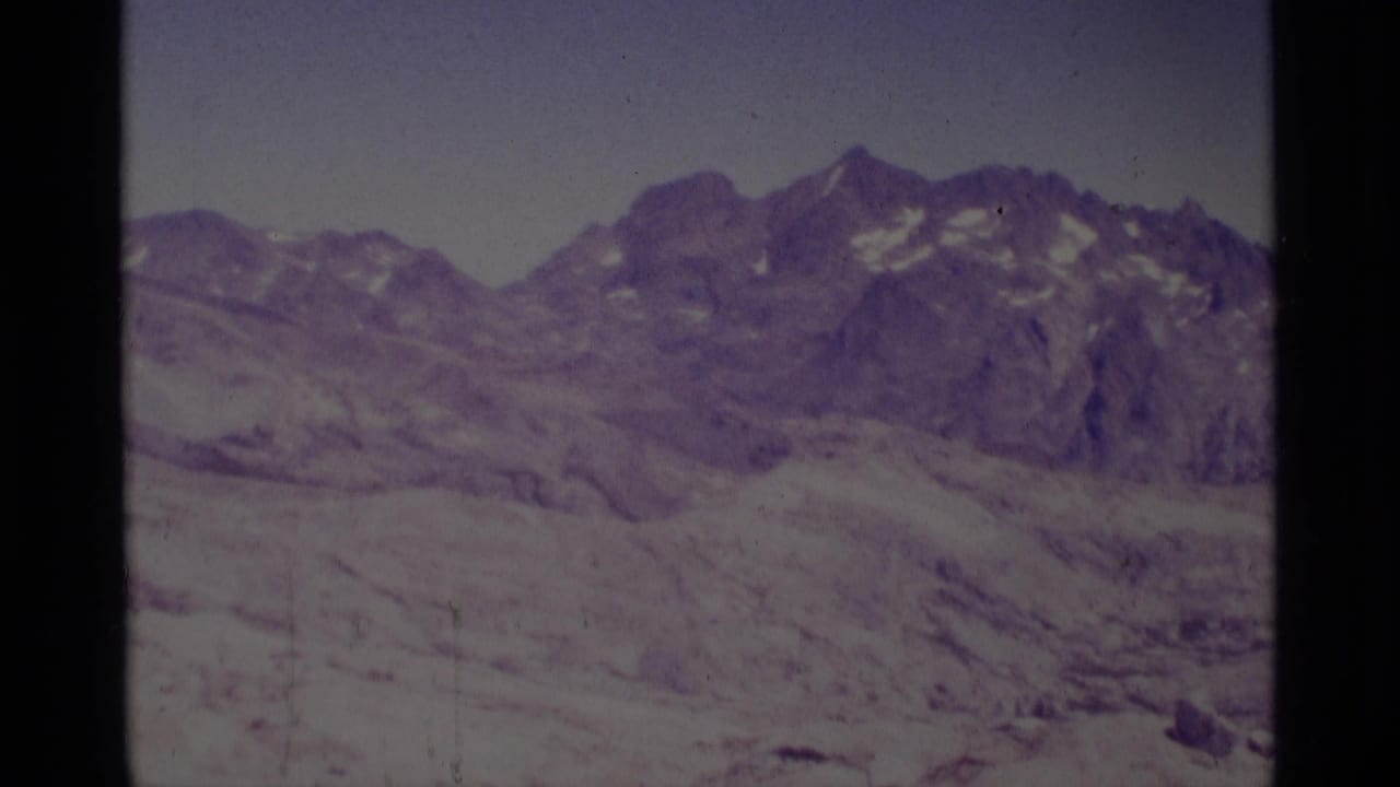 Minaret Wilderness mountain ridge and rocky high-country terrain in faded 1975 8mm home-movie footage.