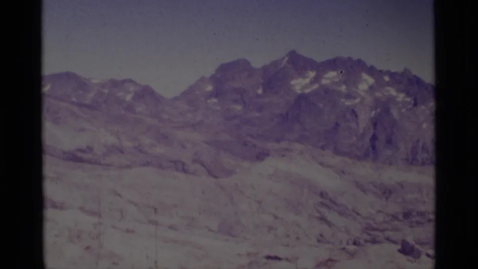 Minaret Wilderness mountain ridge and rocky high-country terrain in faded 1975 8mm home-movie footage.