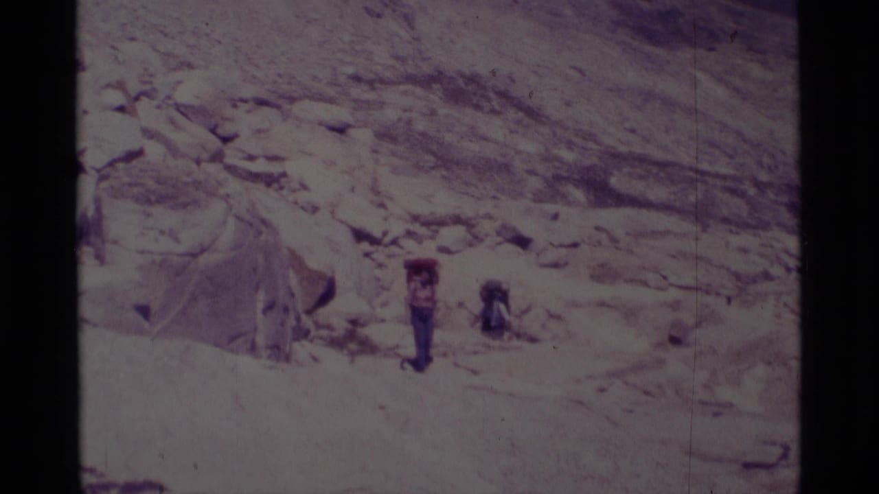 Backpackers in the Minaret Wilderness area appear on a rugged 1975 trail, framed by pale stone and open mountain terrain.