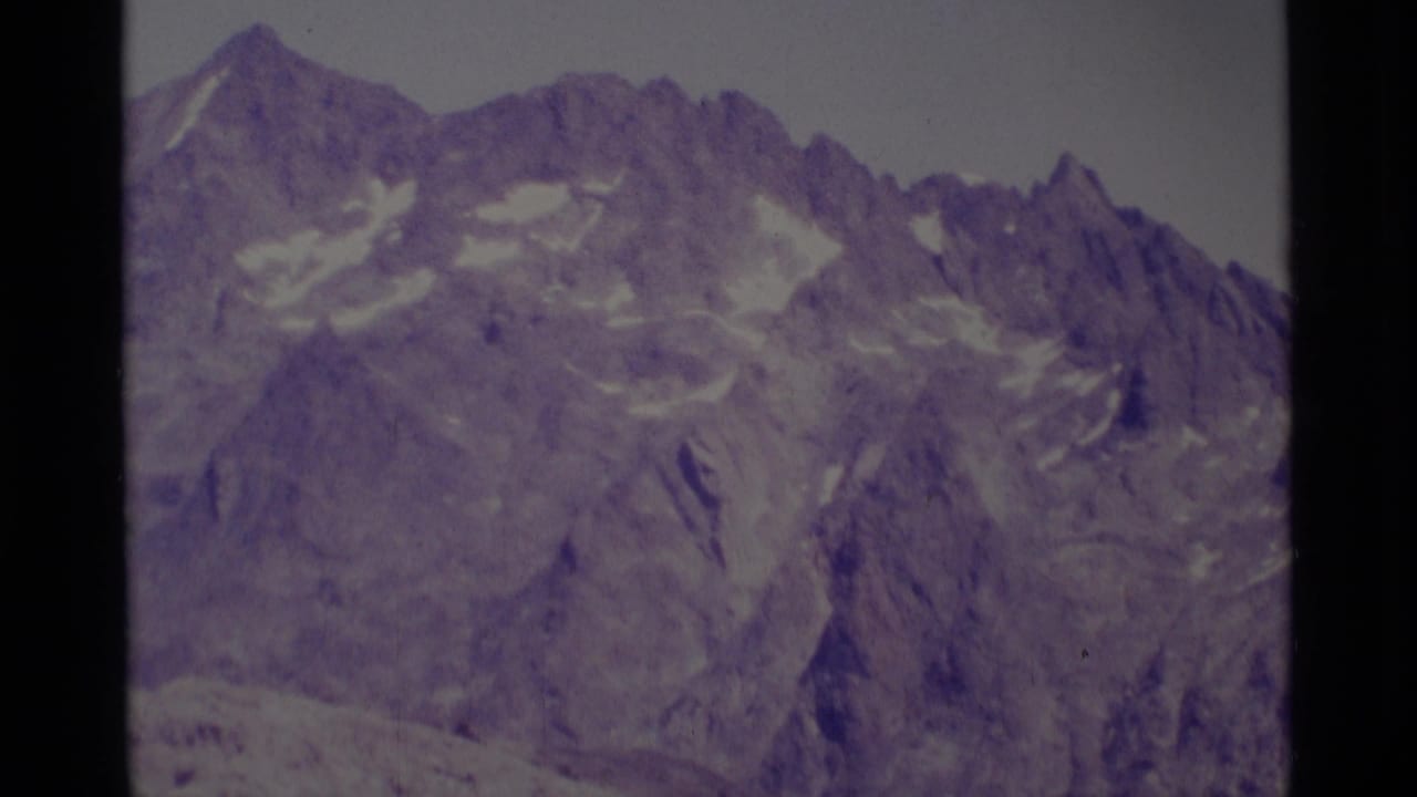 Minaret Wilderness mountain ridge in soft 8mm color, showing steep rock faces and lingering snow.