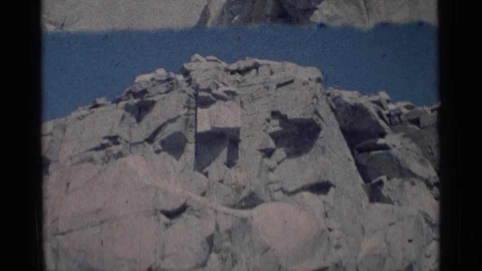 Final 8mm frame of the Minaret Wilderness rock outcropping, with jagged pale stone and shadowed crevices.
