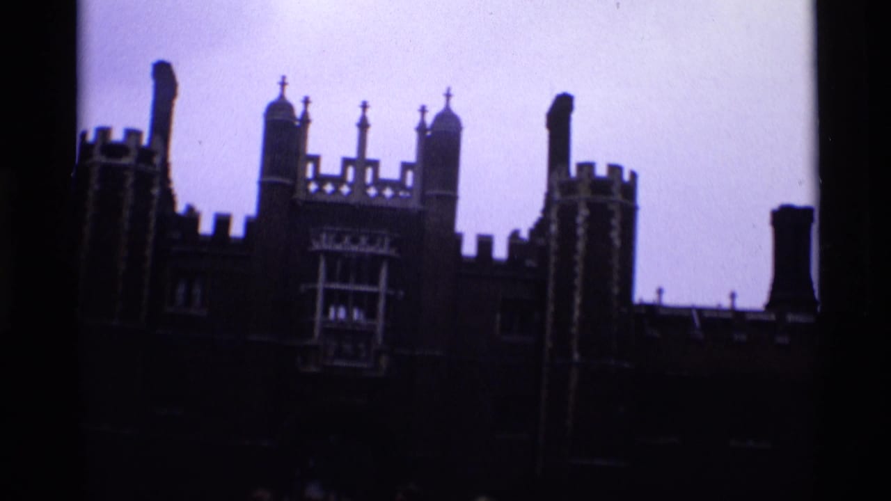 1969 London 8mm frame with the upper roofline of a large historic building silhouetted against pale sky.