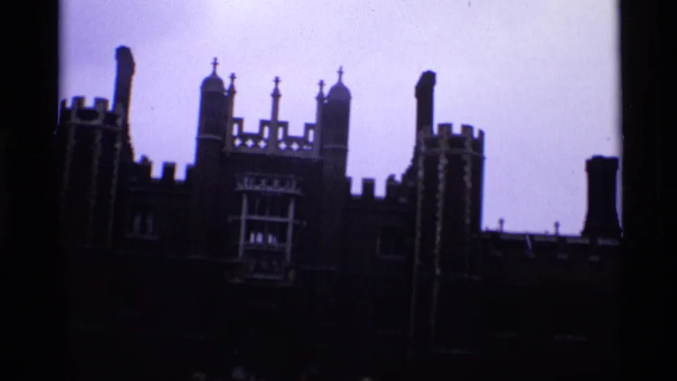 1969 London 8mm frame with the upper roofline of a large historic building silhouetted against pale sky.