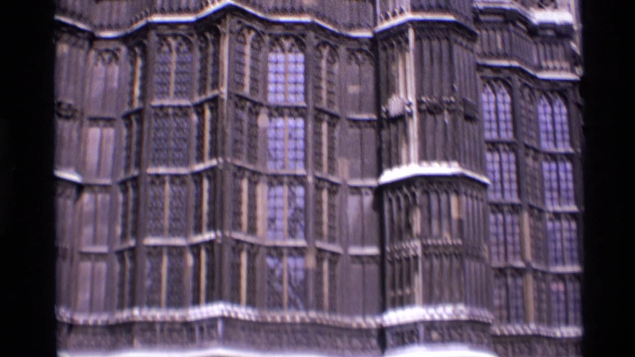 Close view of Gothic stone windows and carved facade details.