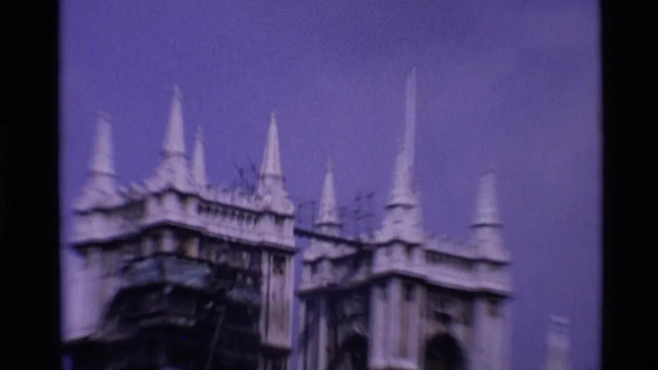 1969 London 8mm frame showing an ornate Gothic roofline with pointed spires and soft handheld blur.