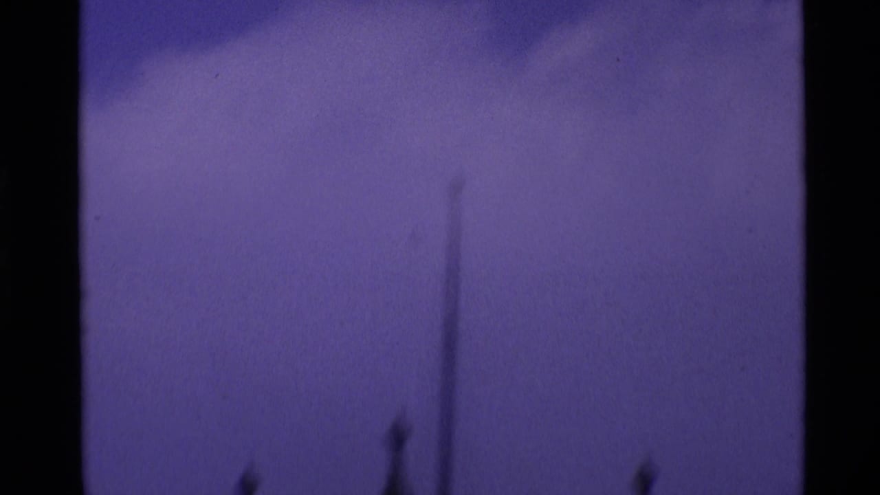 Tall pointed spire seen faintly above a dark lower frame area.