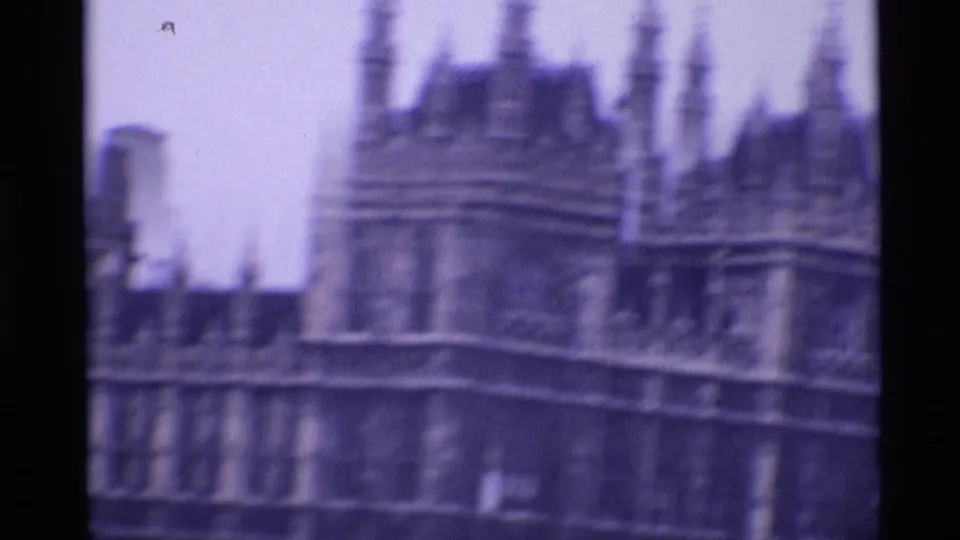 1969 London 8mm frame showing an ornate historic roofline with multiple pointed spires, likely part of the Palace of Westminster.