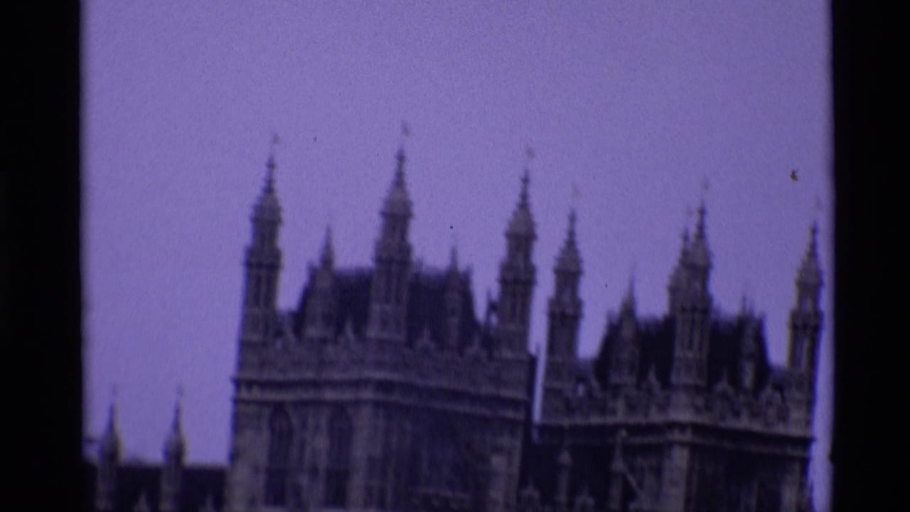 Purple-tinted 8mm frame of the Palace of Westminster roofline and spires.
