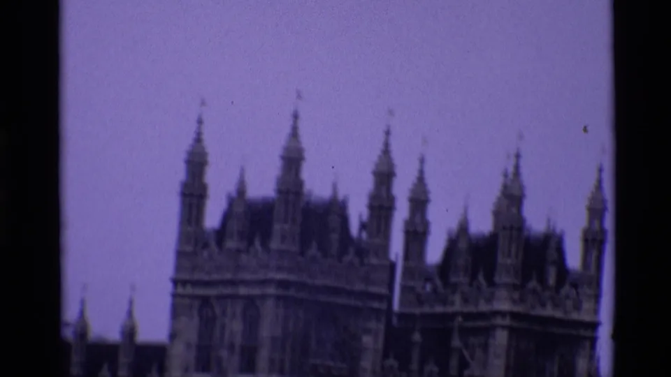 1969 London 8mm view of the Palace of Westminster roofline, showing Gothic spires against a pale sky.