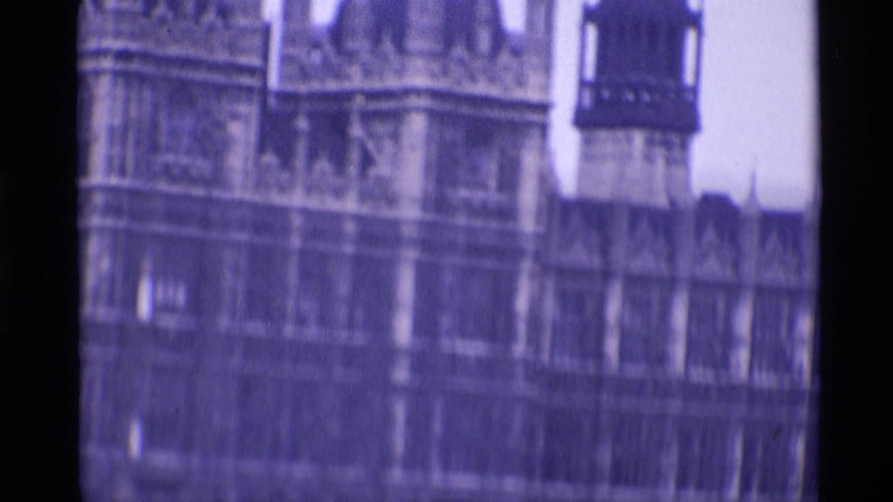1969 London frame showing part of the Palace of Westminster facade, tower section, and ornate stonework in soft focus.