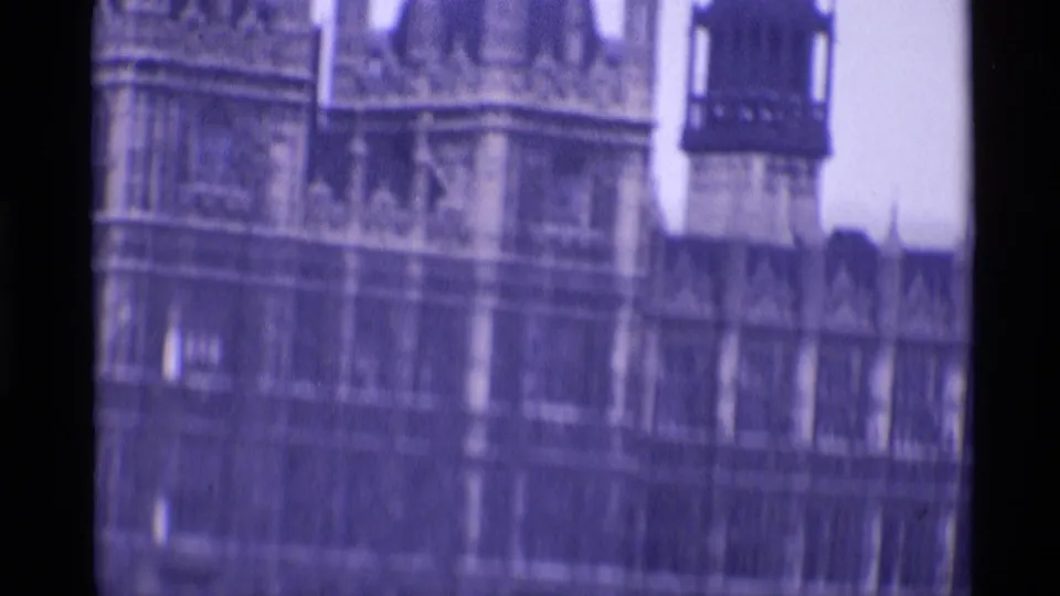 1969 London frame showing part of the Palace of Westminster facade, tower section, and ornate stonework in soft focus.