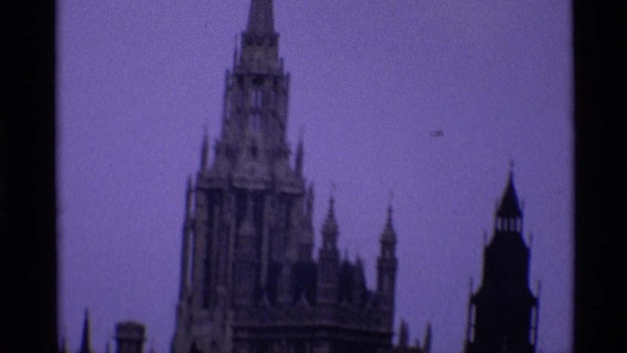 Soft 8mm view of Westminster roofline and Gothic spires against pale sky.