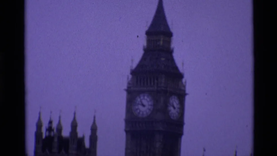 1969 London 8mm frame showing Elizabeth Tower with visible clock faces above the Palace of Westminster roofline.