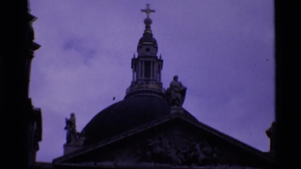 St Paul's Cathedral in London appears in a twilight 8mm frame, with the dome, lantern, statues, and pediment partly visible.