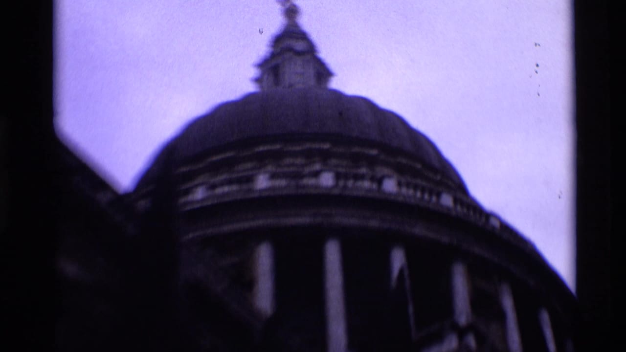 Low-angle 1969 London view of St Paul's Cathedral's dome, columned drum, and small lantern in purple-shifted 8mm film.