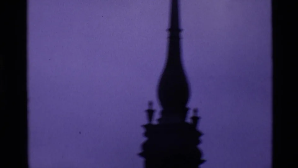 1969 London 8mm frame showing a silhouetted architectural finial or spire detail from the cathedral exterior sequence.