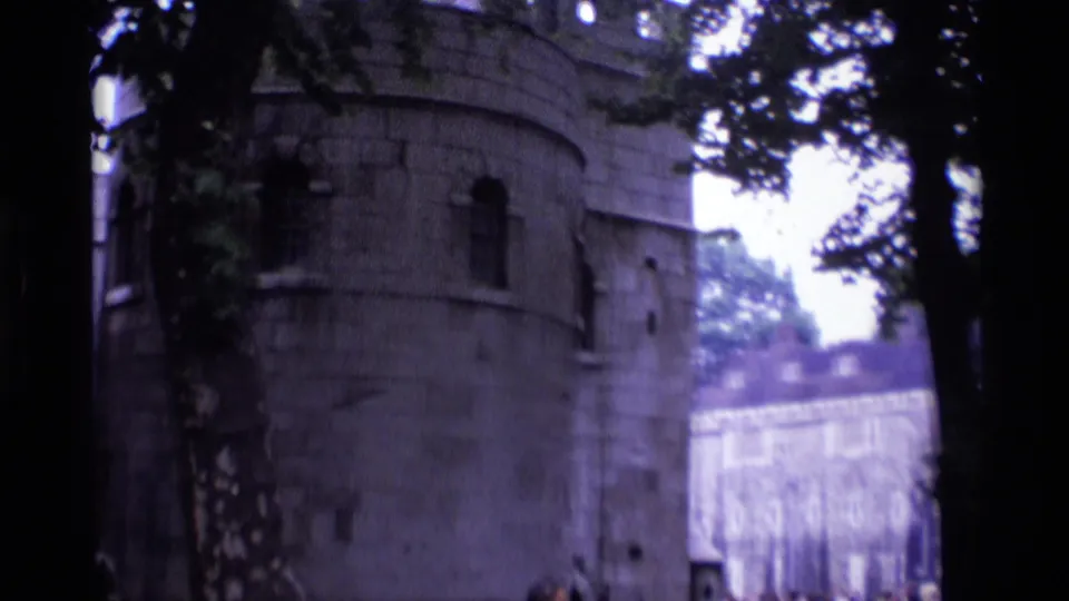 1969 London landmark view showing a rounded stone tower or wall section, trees, and a brighter stone wall in the distance.