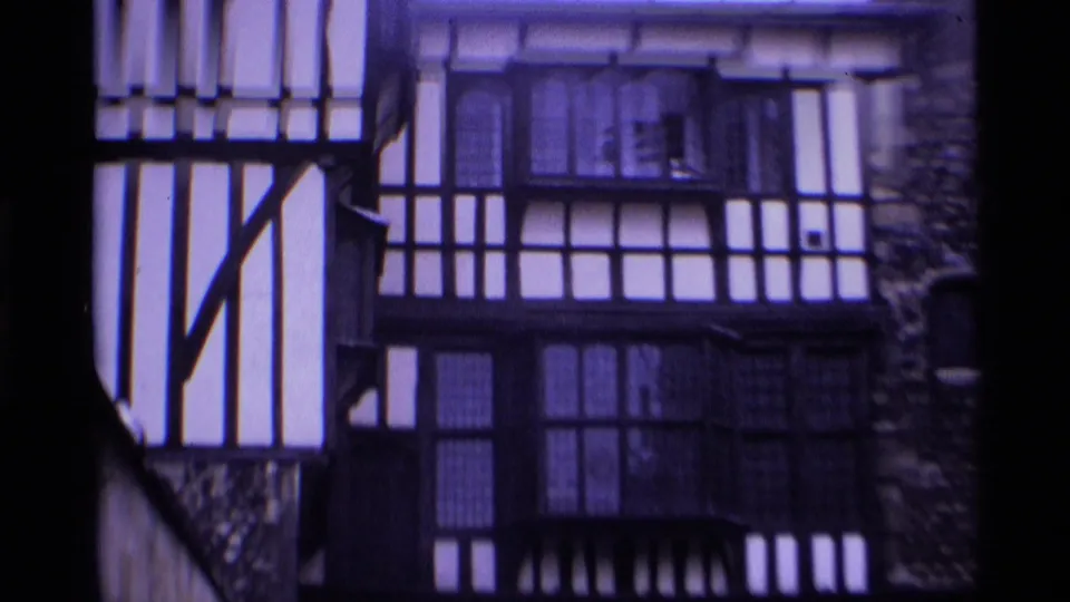 1969 London frame showing a Tudor-style building facade with timber framing and large multi-paned windows.