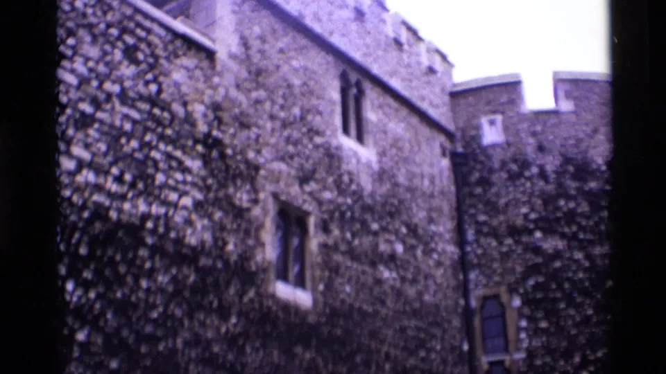 Tower of London stone walls and small windows seen from a visitor's handheld 8mm perspective in 1969.
