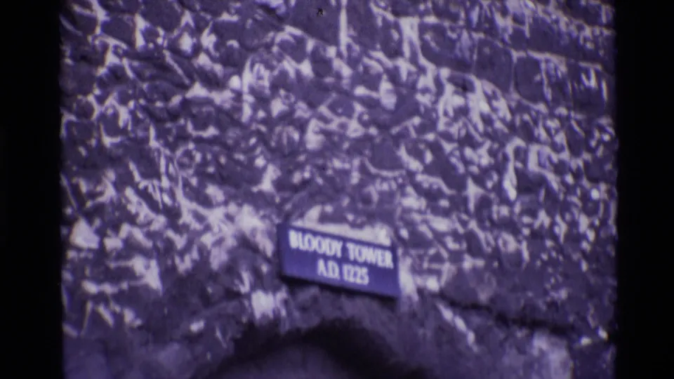 Close 1969 8mm view of the Bloody Tower sign mounted on textured stonework at the Tower of London.