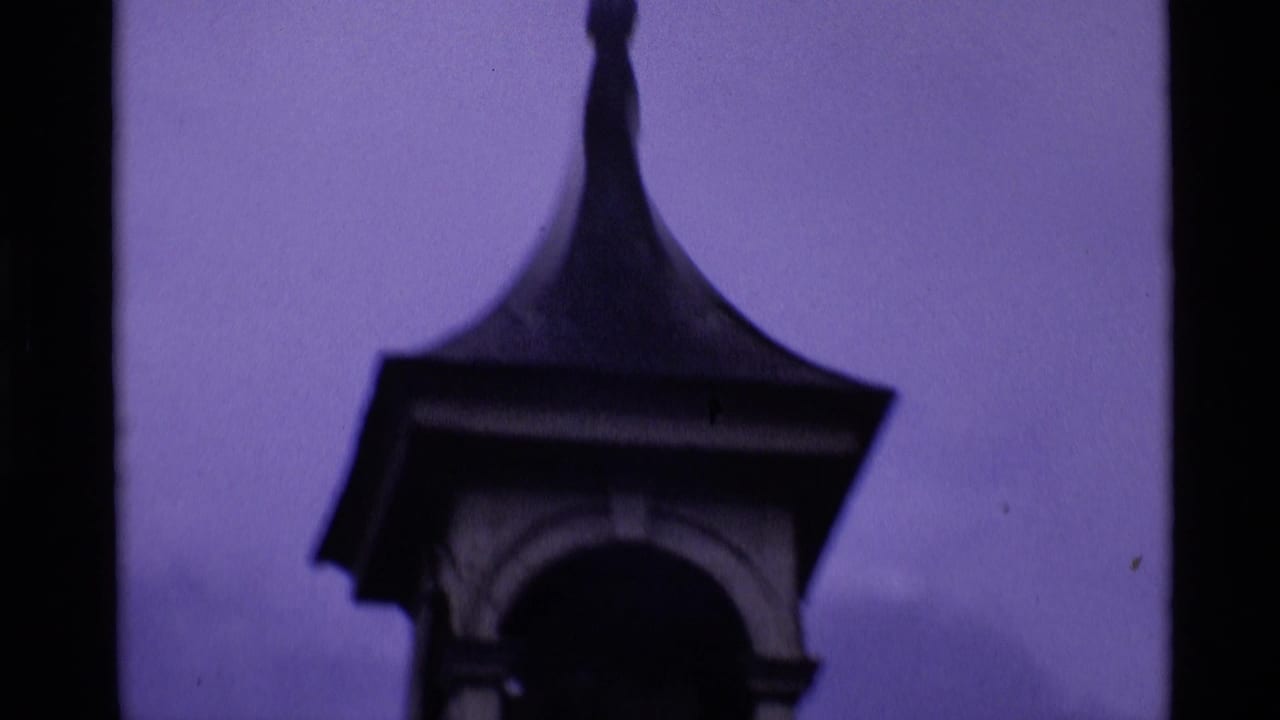 Dark spire and arched tower detail against a purple sky.