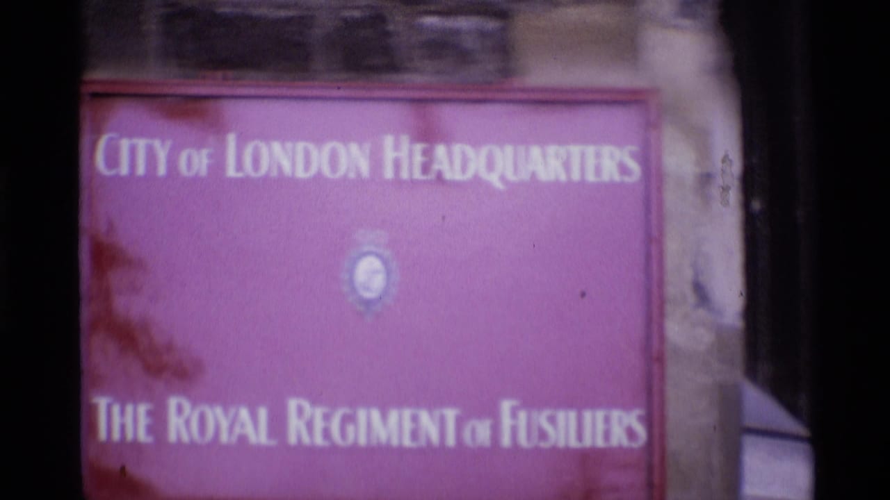 1969 London 8mm frame showing a purple City of London Headquarters sign for The Royal Regiment of Fusiliers mounted on stonework.