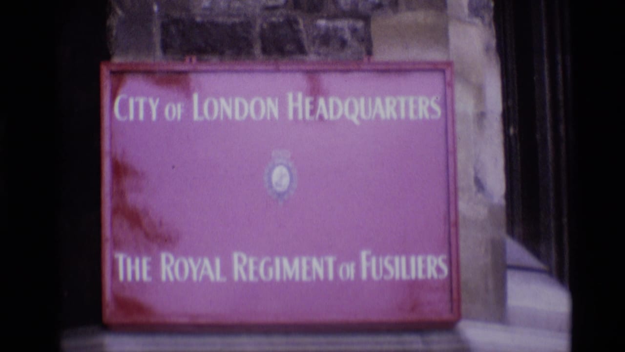 1969 London home-movie frame with the City of London Headquarters and Royal Regiment of Fusiliers sign seen from a slightly different angle.