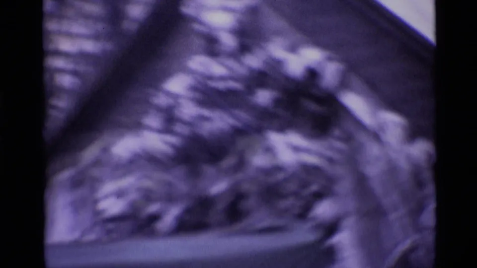 Blurred 1969 London 8mm frame showing what appears to be a sculptural figure or relief detail near the headquarters exterior.