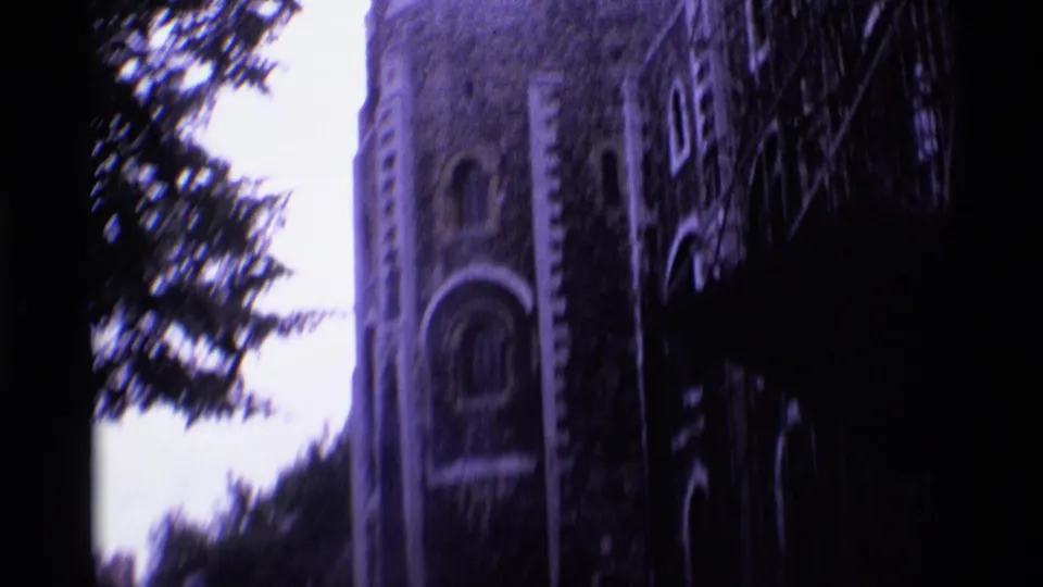 A historic London stone facade with an arched window, trees and visible scaffolding appears in the 1969 8mm footage.