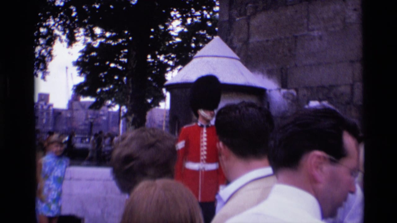 1969 London home-movie frame showing tourists near a ceremonial guard by Middle Tower stonework.