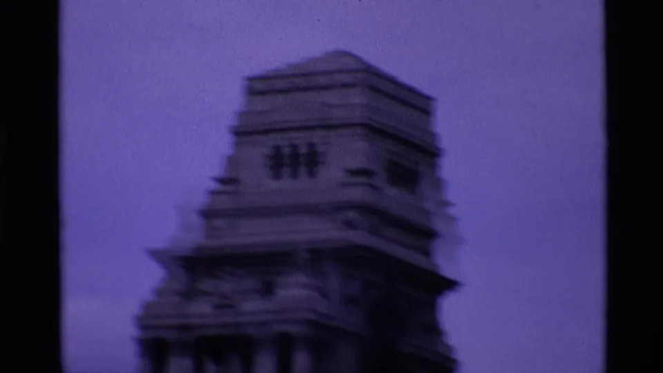 Soft 8mm view of the upper Middle Tower structure in London, seen against a purple-tinted sky.