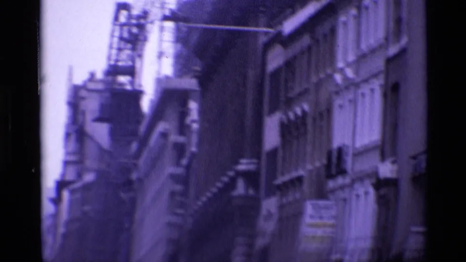 1969 London street facade with a construction crane visible above older urban buildings.